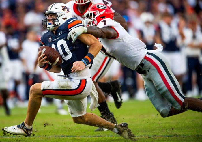 Auburn Tigers quarterback Bo Nix (10) is sacked by Georgia Bulldogs linebacker Quay Walker (7). Jake Crandall / USA TODAY NETWORK